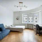 Bright and spacious apartment in Tallinn with modern decor, a cosy sofa, and a dedicated work area.