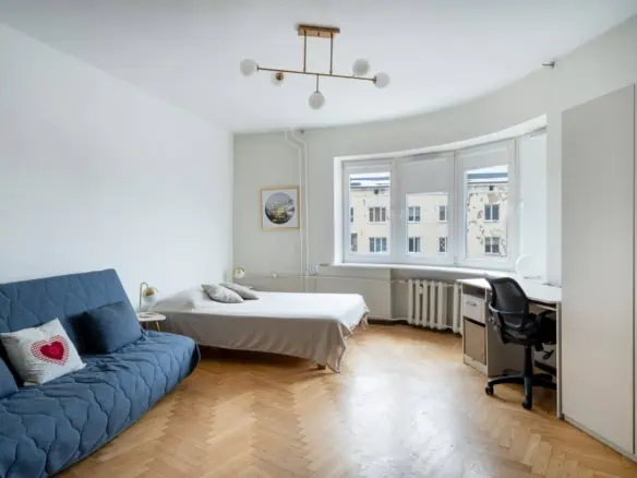 Bright and spacious apartment in Tallinn with modern decor, a cosy sofa, and a dedicated work area.