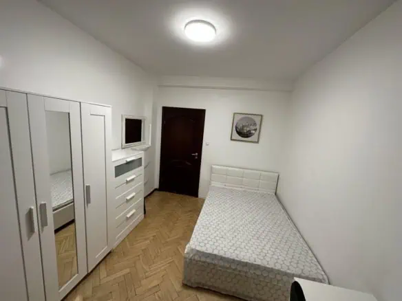 Modern white furniture in a comfy Tallinn hostel room, perfect for short stays, with free Wi-Fi and essential amenities.