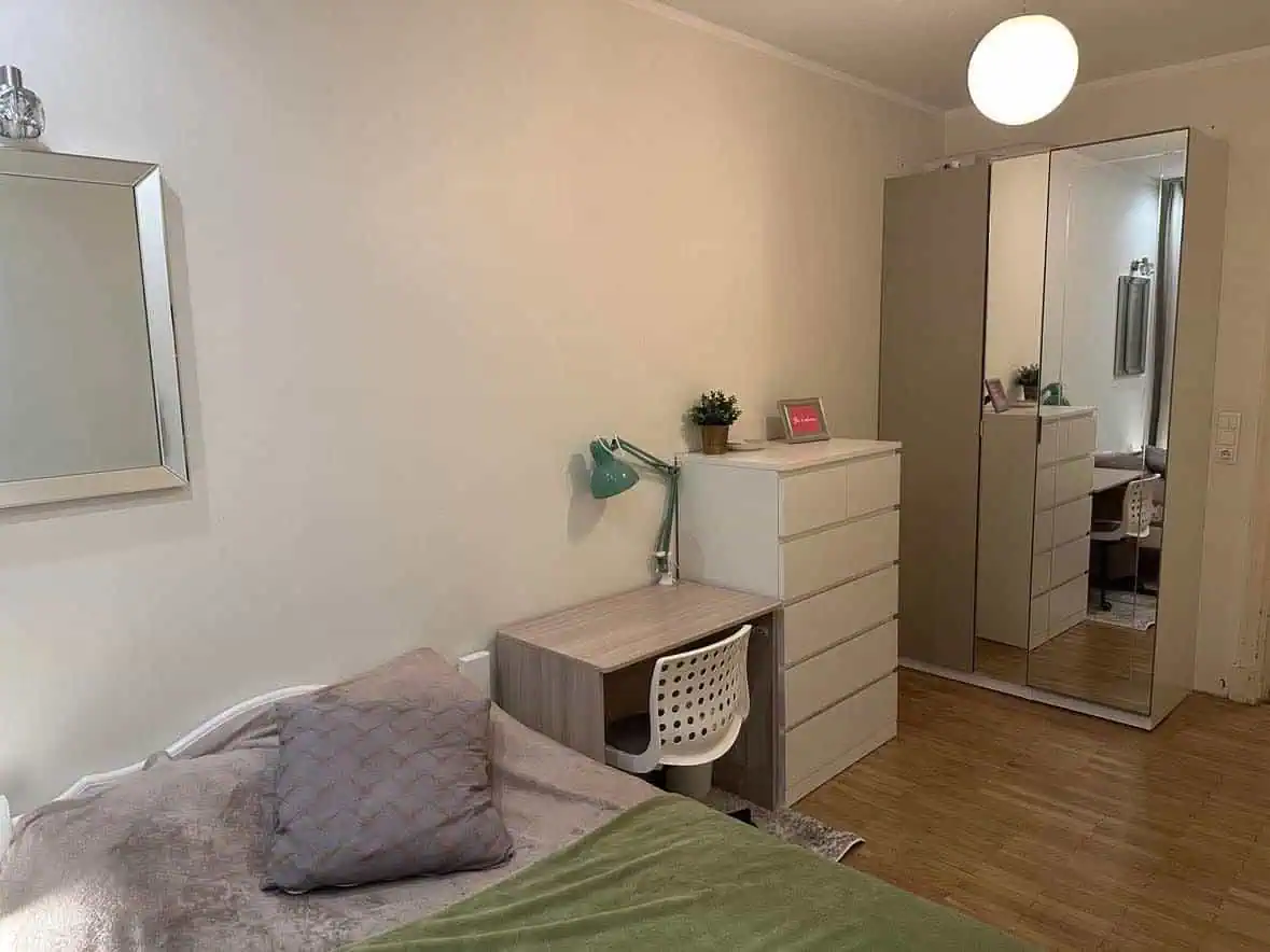 Bright, stylish bedroom with desk, mirror wardrobe, and comfortable bedding in Tallinn.