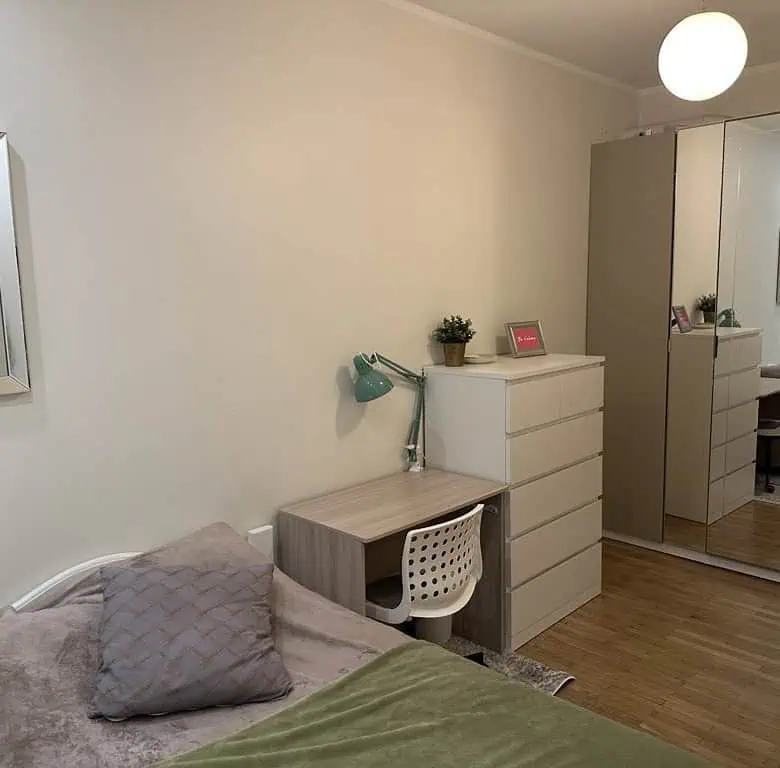 Bright modern bedroom with wardrobe and study area in Tallinn apartment.