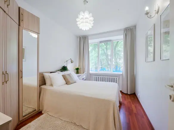 Bright hotel room with comfortable bed and scenic city view in Tallinn.