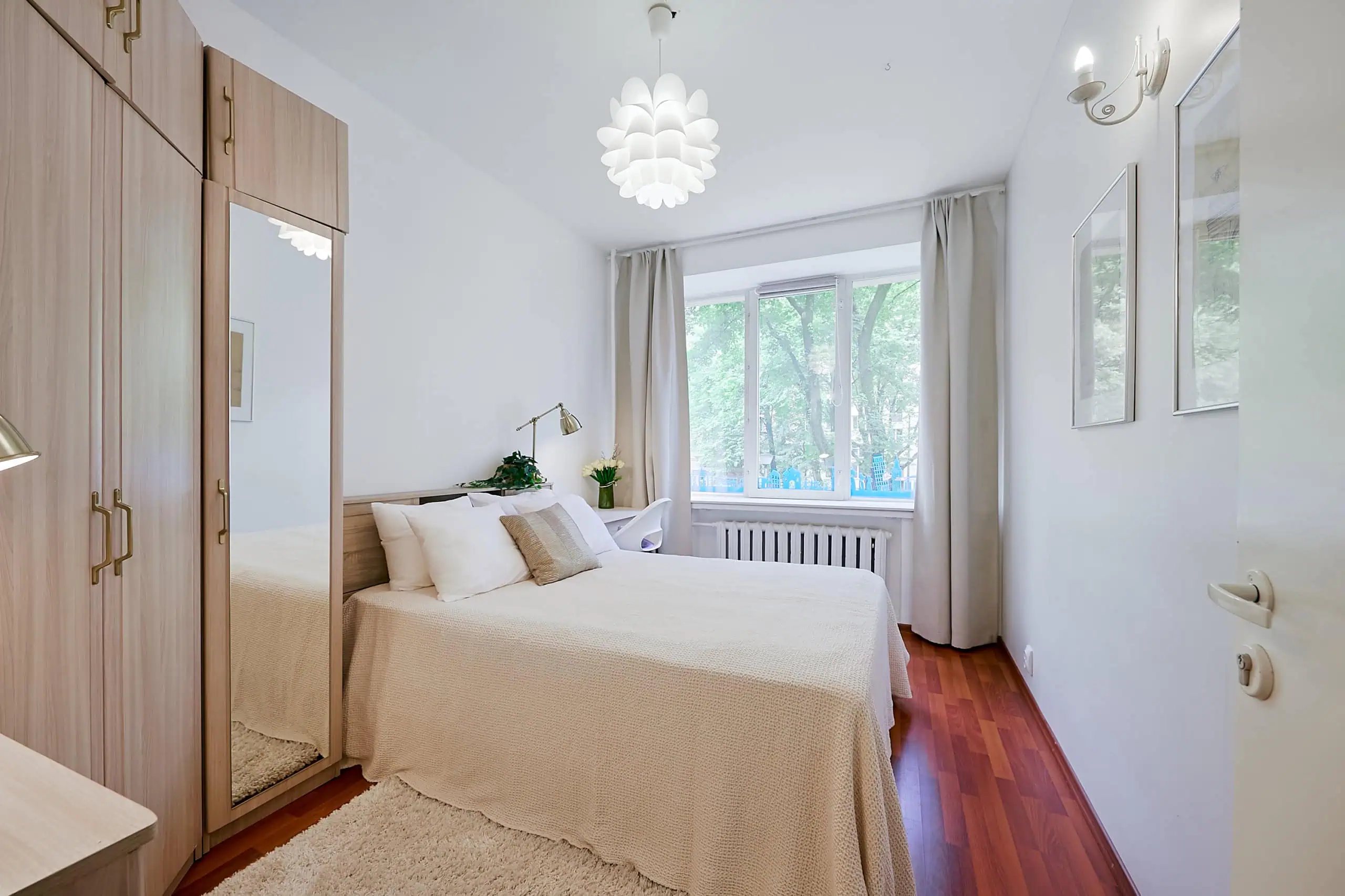 Bright hotel room with comfortable bed and scenic city view in Tallinn.