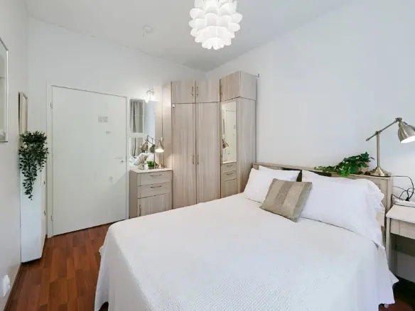 Comfortable ensuite room with elegant furnishings and natural lighting in Tallinn.