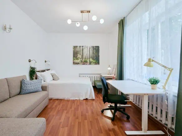 Bright, stylish hotel room in Tallinn with comfortable beds, workspace, and natural light.