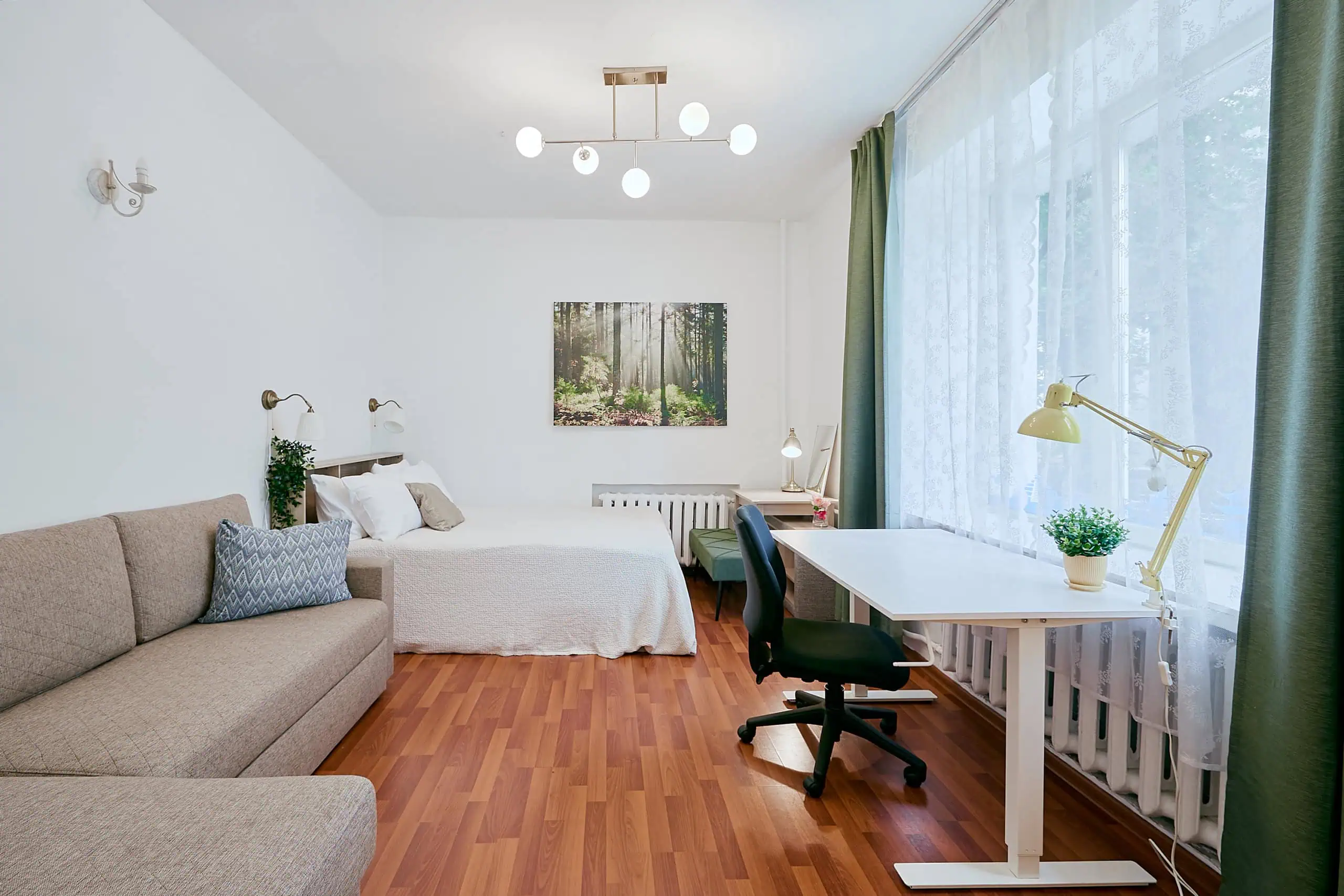 Modern Tallinn apartment with cozy interior design and workspace options. Bright, stylish hotel room in Tallinn with comfortable beds, workspace, and natural light.