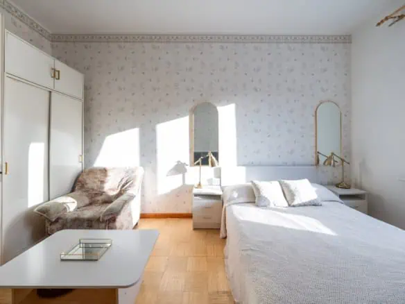 Comfortable Tallinn guest room with elegant furnishings and ample natural light, ideal for a peaceful visit.