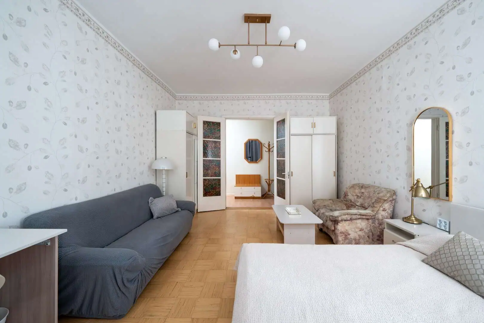 Cozy Tallinn apartment living room with vintage decor and modern furnishings.