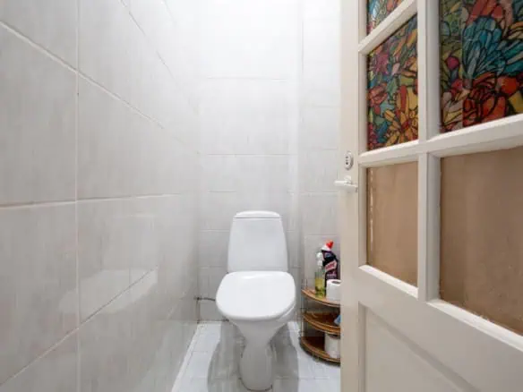 Cozy private toilet room in Koolrooms Tallinn hostel, simple clean design.