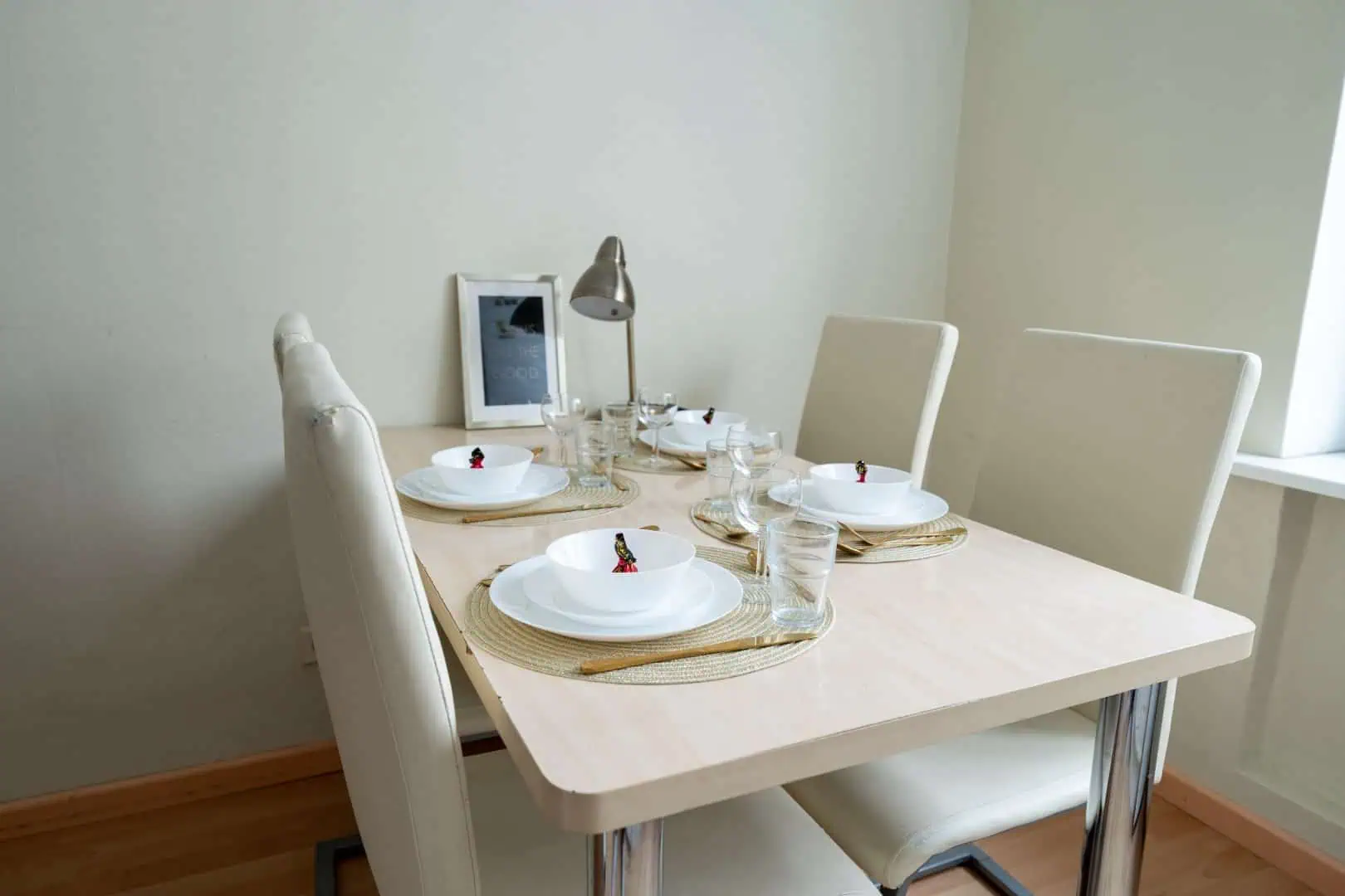 Bright, modern dining area with neatly arranged tableware, perfect for comfortable guest experiences at Koolrooms Tallinn.