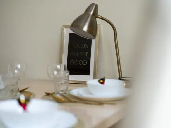 Contemporary bedroom or living space with elegant lighting and motivational art at Koolrooms Tallinn.