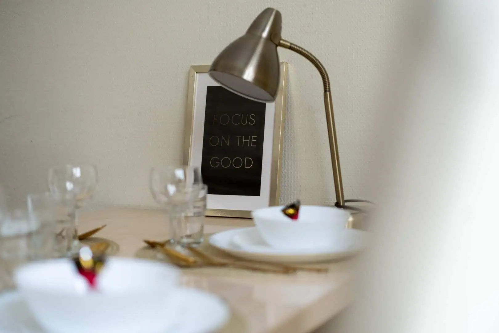 Contemporary bedroom or living space with elegant lighting and motivational art at Koolrooms Tallinn.