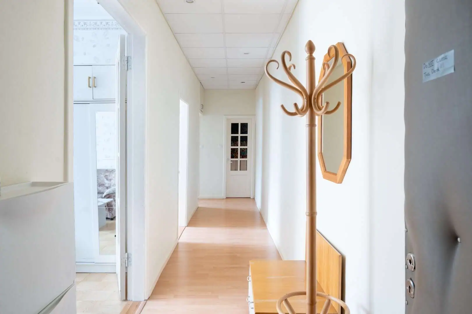 Bright corridor featuring a wooden coat rack and mirror at Koolrooms Tallinn guesthouse.