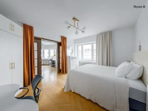 Bright hotel room in Tallinn with large windows, stylish decor, and comfortable furnishings. Perfect for travellers.