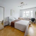 Bright, clean Tallinn accommodation with a comfortable bed, workspace, and natural light. (This room has light-blocking curtains which were unfortunately in dry cleaning day of photography)