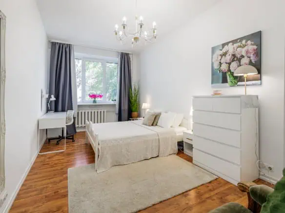 Bright hotel room in Tallinn with stylish decor, large window, and comfortable bedding.