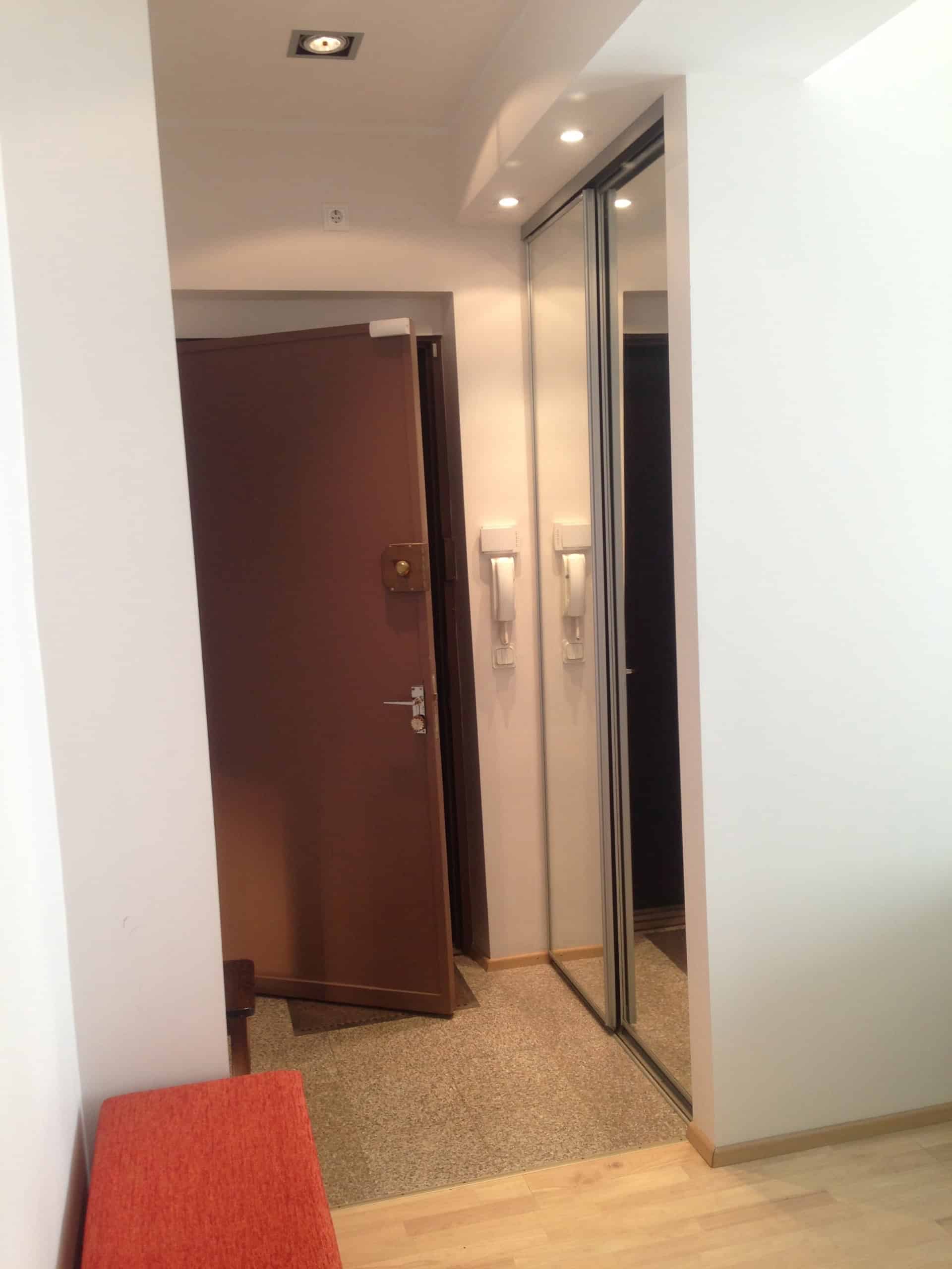 Cozy Tallinn student apartment Entrance. Comfortable modern student apartment entrance with mirror closet and secure door.