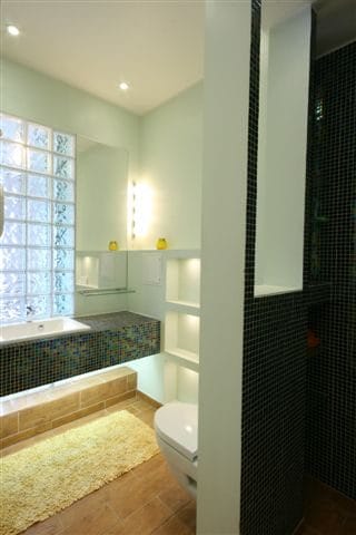Stylish Ensuite Bathroom. Modern bathroom with mosaic tiles, bright lighting, and elegant fixtures in Tallinn boutique student apartment.