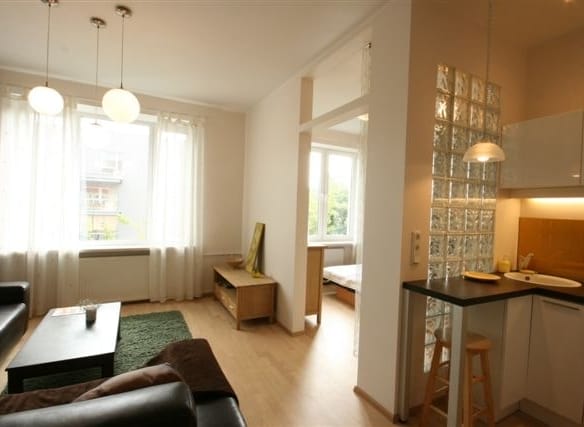 Bright, stylish living room with large windows and cosy furnishings in Tallinn.